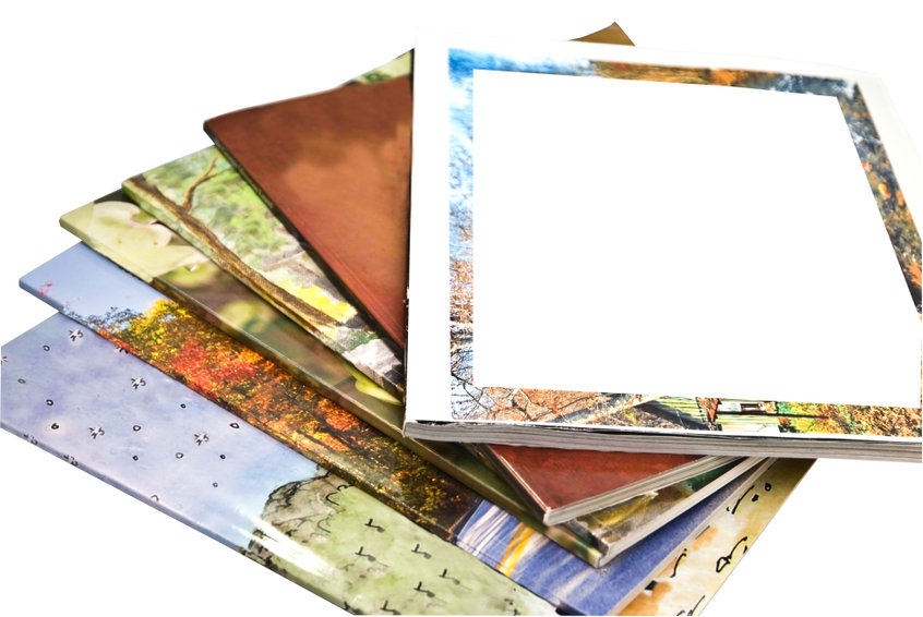 A stack of colorful magazines, isolated, with copy space on the cover of one.